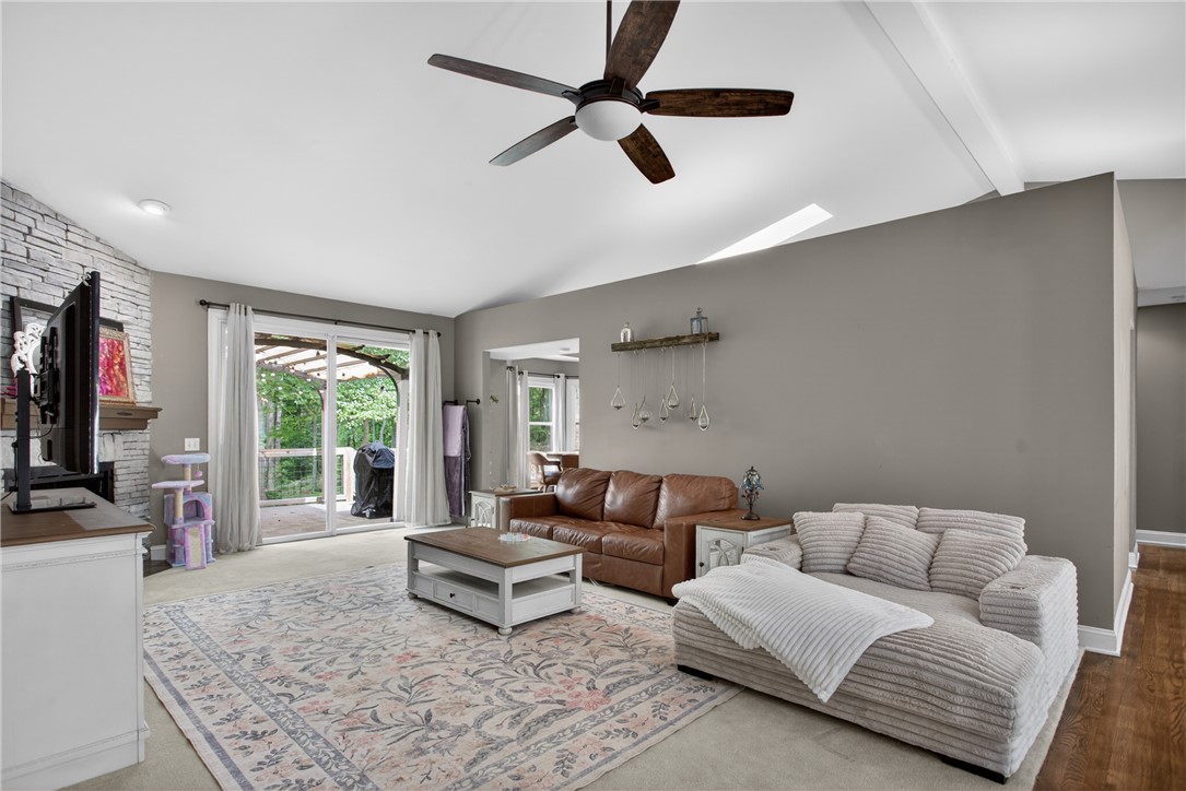 136 Loran Pointe Circle Seneca, SC 29672 - Photo 4 of 50 Step into a sun-filled living space featuring a cozy fireplace and convenient outdoor access.