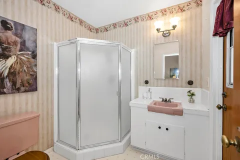 a bedroom with a bed and a night stand