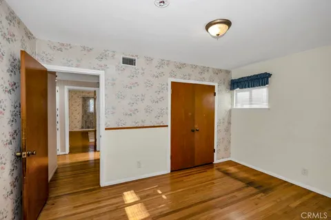a dinning table and chairs in a room with a chandelier
