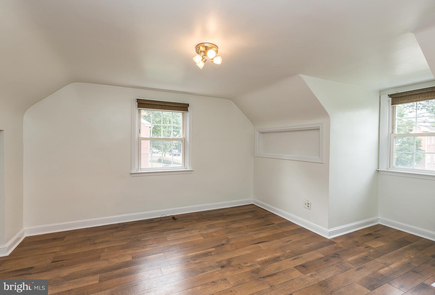 339 East Spring Avenue Ardmore, PA 19003 - Photo 21 of 44 an empty room with wooden floor and windows