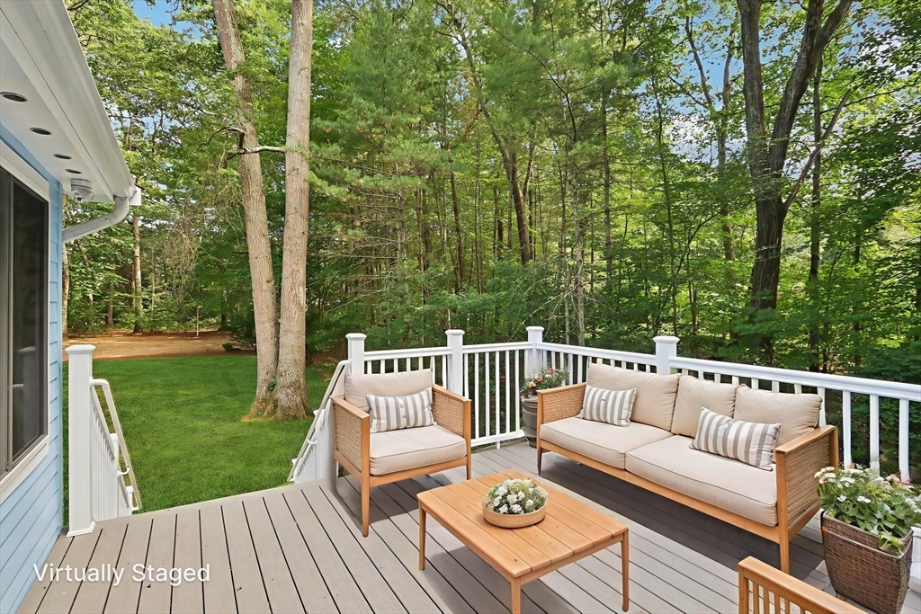 196 Hudson Road Stow, MA 01775 - Photo 1 of 31 a roof deck with couches and wooden floor