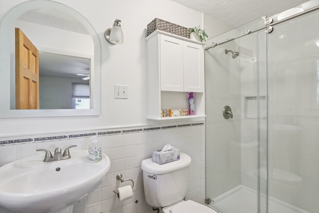 196 Hudson Road Stow, MA 01775 - Photo 16 of 31 a bathroom with a sink toilet and shower
