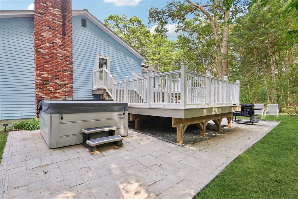 196 Hudson Road Stow, MA 01775 - Photo 28 of 31 a view of a patio with table and chairs with wooden fence and plants