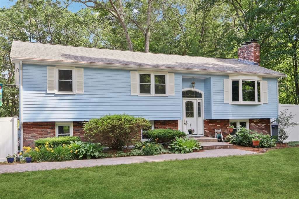196 Hudson Road Stow, MA 01775 - Photo 3 of 31 a front view of a house with a yard and potted plants