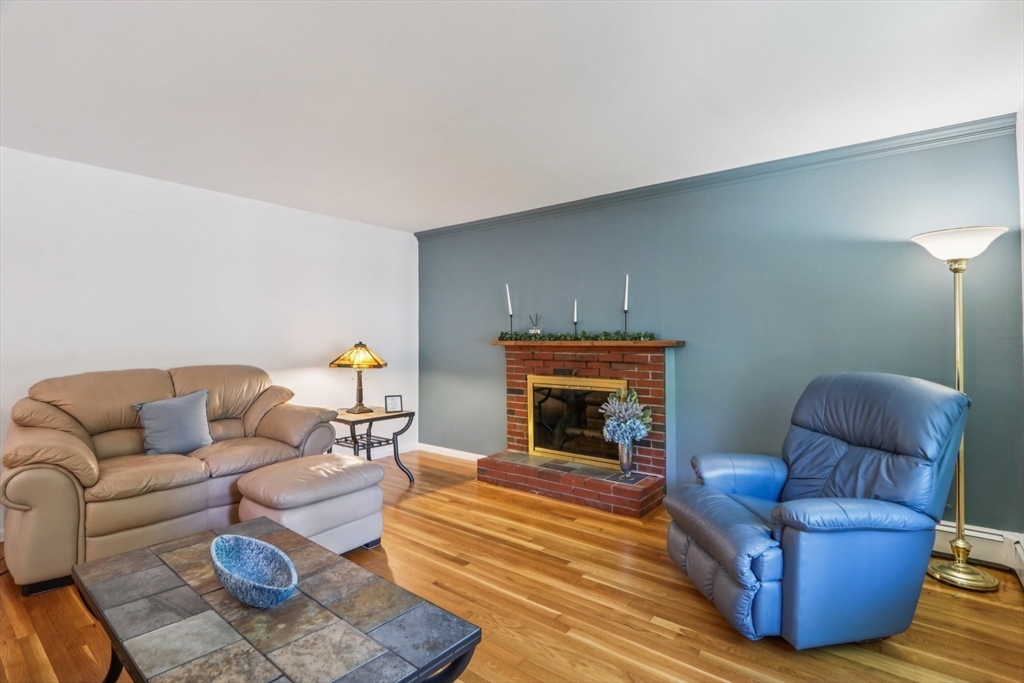 196 Hudson Road Stow, MA 01775 - Photo 6 of 31 a living room with furniture and a fireplace