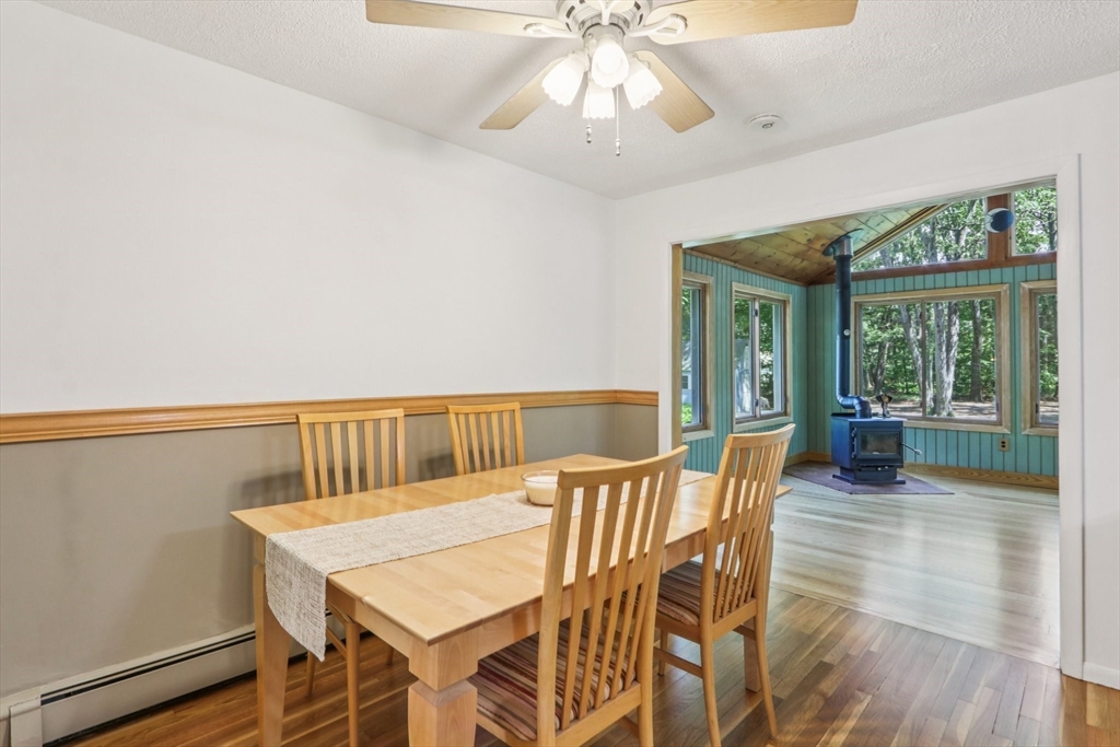 196 Hudson Road Stow, MA 01775 - Photo 7 of 31 a view of a dining room with furniture wooden floor and chandelier