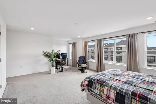a bedroom with furniture and a rug