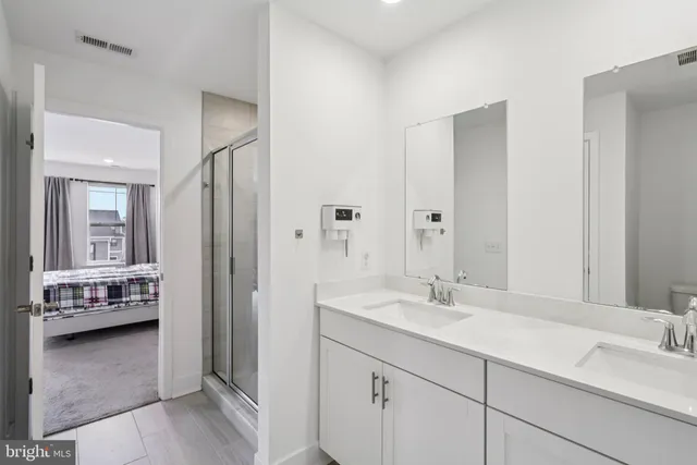 a bathroom with a tub shower and a sink
