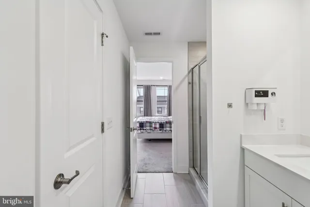 a view of a kitchen with wooden floor and electronic appliances