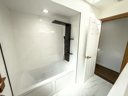 a bathroom with a bathtub and a shower