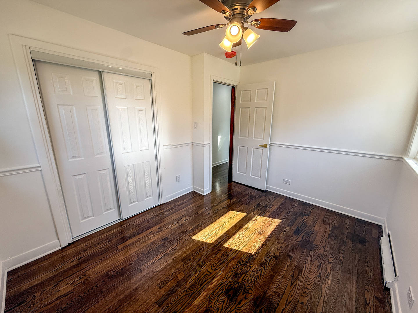 888 Woodstock Road Olympia Fields, IL 60461 - Photo 25 of 30 a view of an empty room with wooden floor and a window