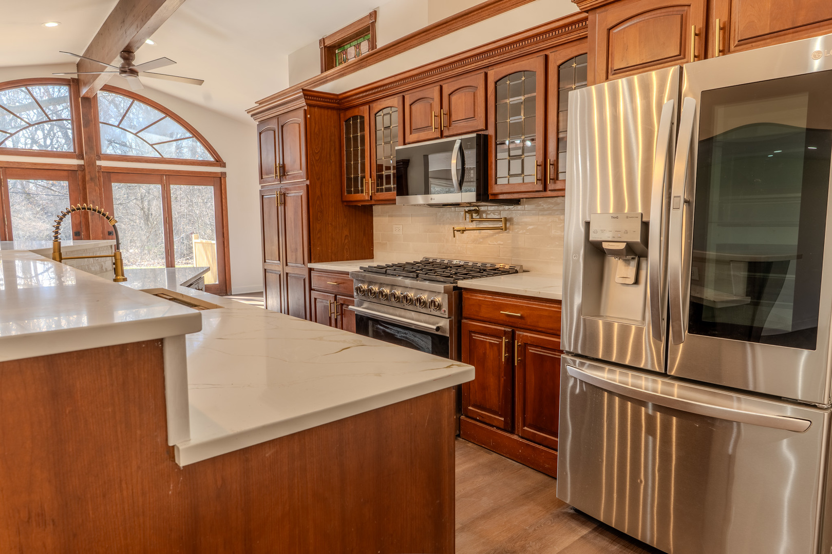 888 Woodstock Road Olympia Fields, IL 60461 - Photo 9 of 30 a kitchen with stainless steel appliances granite countertop a refrigerator a stove and a sink with wooden floor