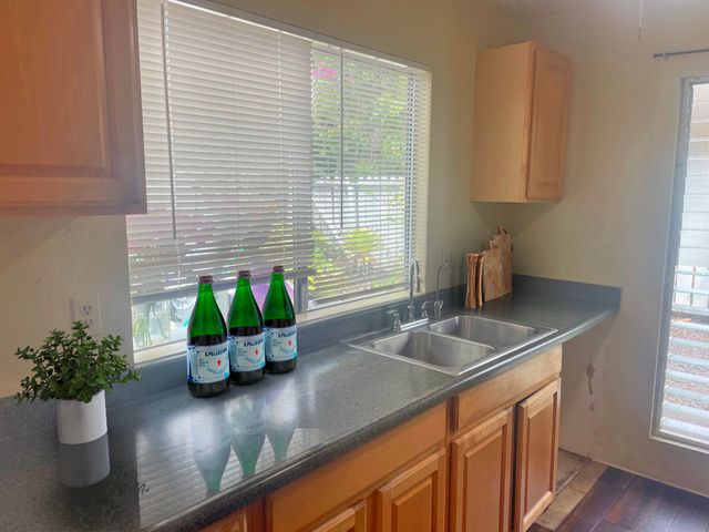 a kitchen with a sink a counter and a window