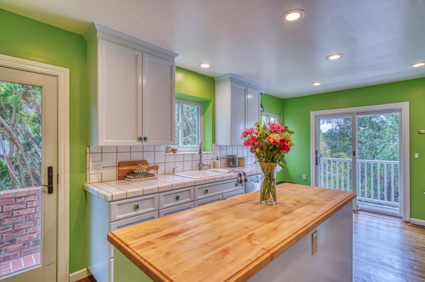 504 Cuesta Drive Aptos, CA 95003 - Photo 24 of 76 a kitchen with kitchen island granite countertop wooden cabinets and a large window