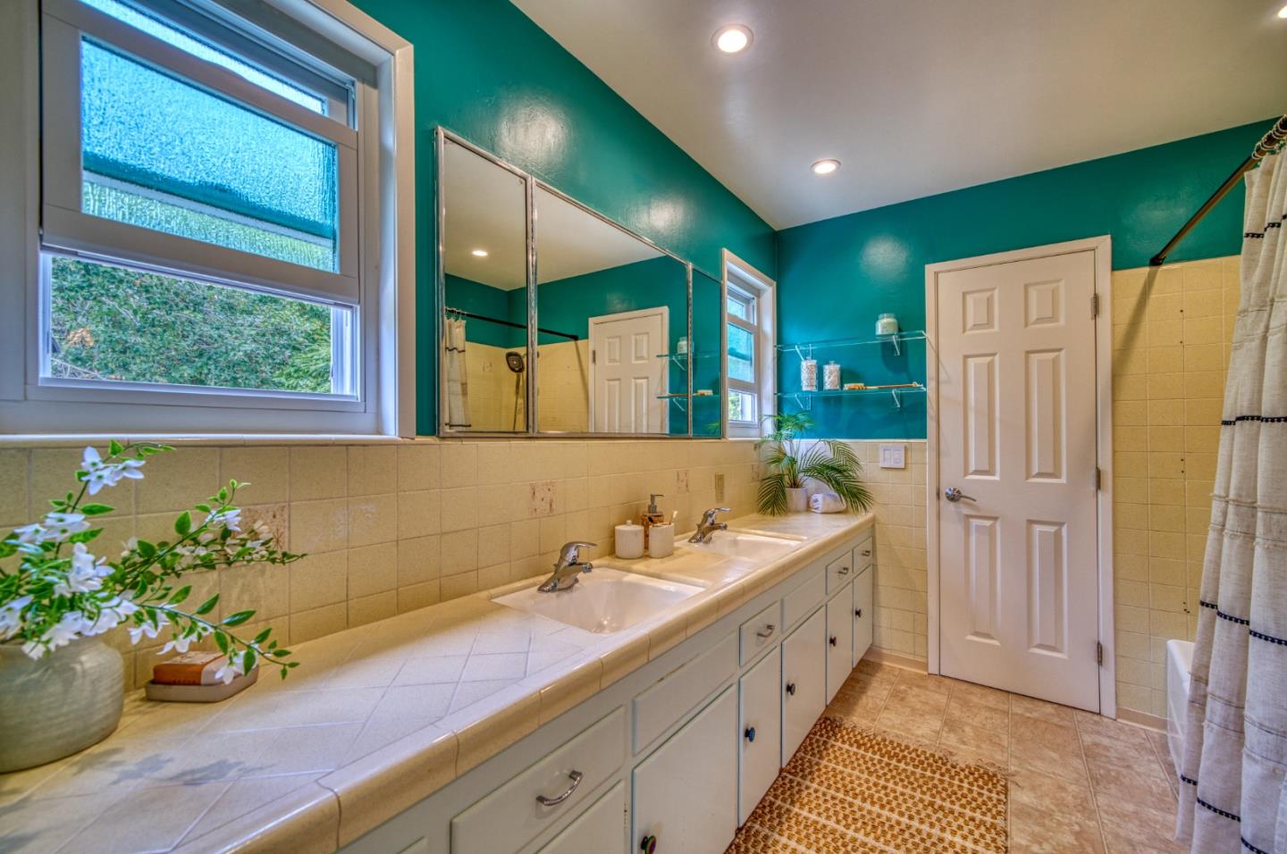 504 Cuesta Drive Aptos, CA 95003 - Photo 32 of 76 a spacious bathroom with a double vanity sink and a large mirror