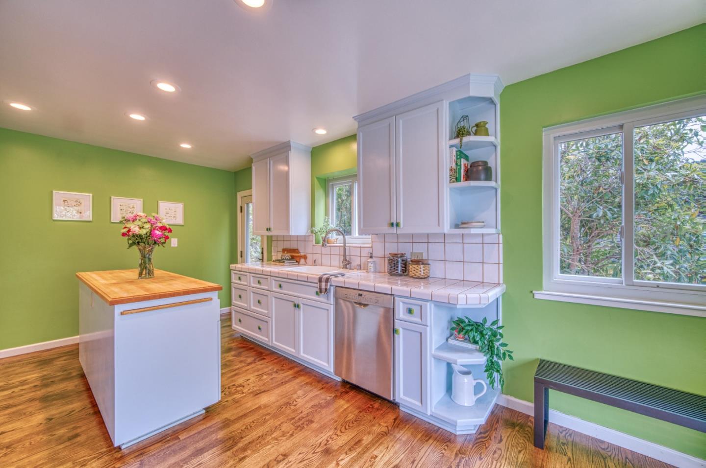 504 Cuesta Drive Aptos, CA 95003 - Photo 8 of 76 a kitchen with kitchen island a stove a sink wooden floor and a dining table