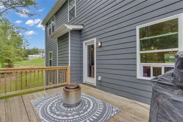 a brick house with large windows and potted plants