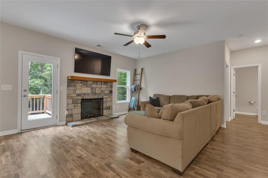 313 Lucy Lane Carrollton, GA 30117 - Photo 17 of 46 a living room with furniture a flat screen tv and a fireplace