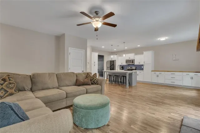 a living room with furniture and kitchen view