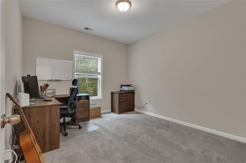 313 Lucy Lane Carrollton, GA 30117 - Photo 20 of 46 a view of a workspace with furniture and a window