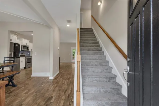 a view of entryway and hall with wooden floor