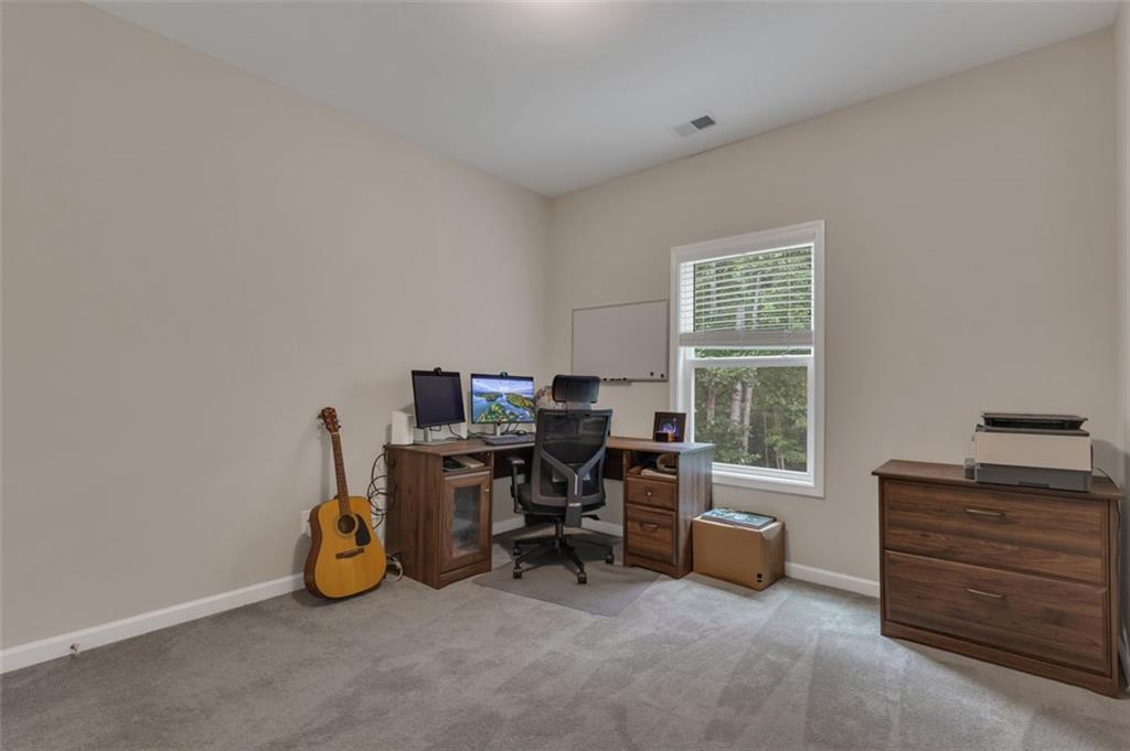 313 Lucy Lane Carrollton, GA 30117 - Photo 21 of 46 a view of a workspace with furniture and a window