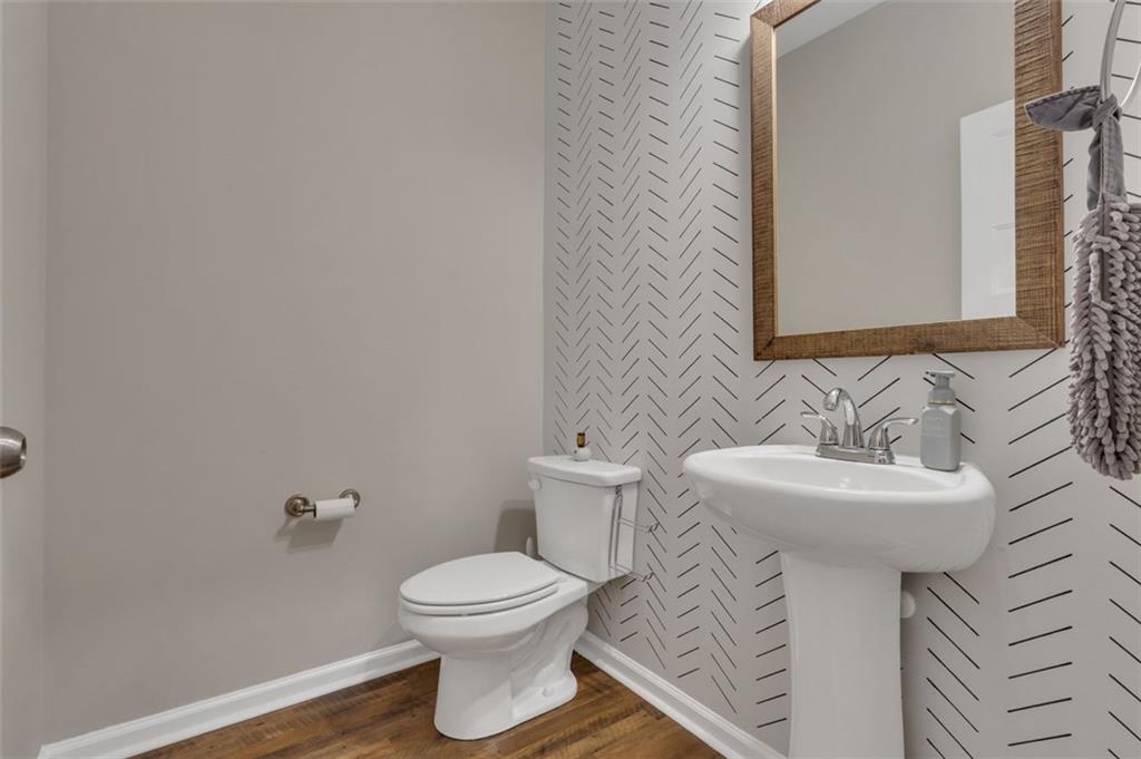 313 Lucy Lane Carrollton, GA 30117 - Photo 22 of 46 a bathroom with a sink a toilet and mirror