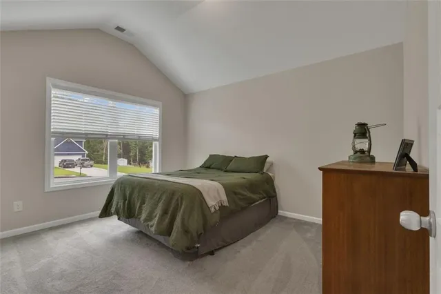 a bed sitting in a bedroom next to a window