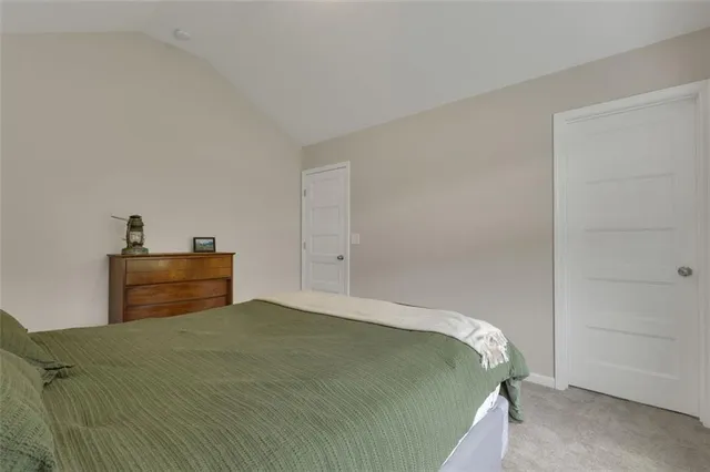 a bedroom with a bed and a lamp