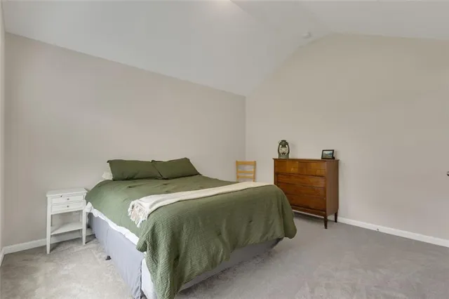 a bedroom with a bed and a lamp