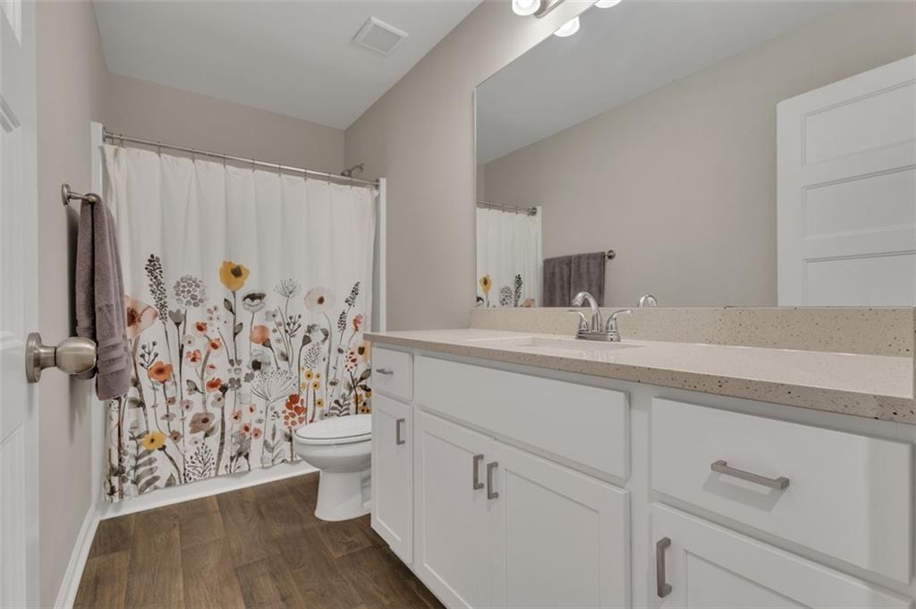313 Lucy Lane Carrollton, GA 30117 - Photo 26 of 46 a bathroom with a sink a toilet and shower curtain
