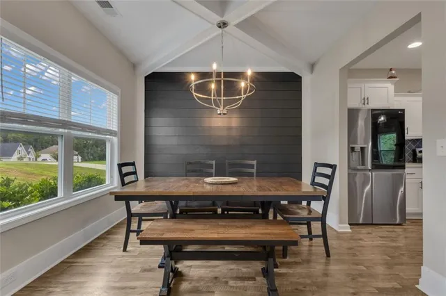 a view of a dining room with furniture window and wooden floor