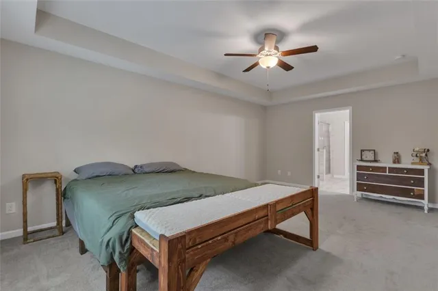 a bed room with a bed and a ceiling fan