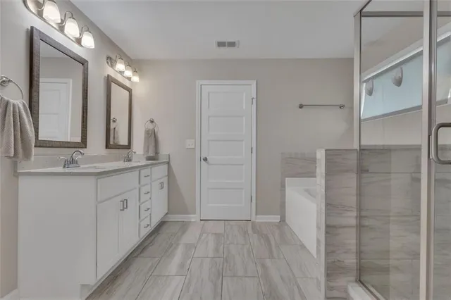 a bathroom with a double vanity sink and a mirror