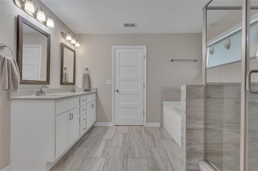 313 Lucy Lane Carrollton, GA 30117 - Photo 37 of 46 a bathroom with a double vanity sink and a mirror