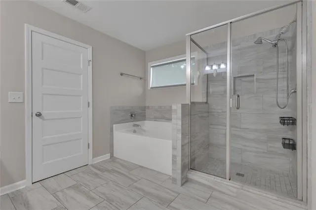 a bathroom with a shower and a sink