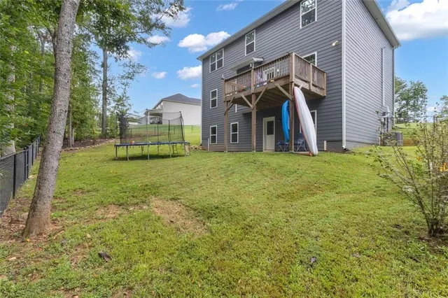 a view of a house with a yard and sitting area