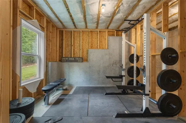 a room with gym equipment and windows