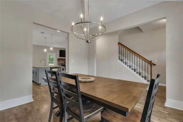 a view of a dining room with furniture and a chandelier
