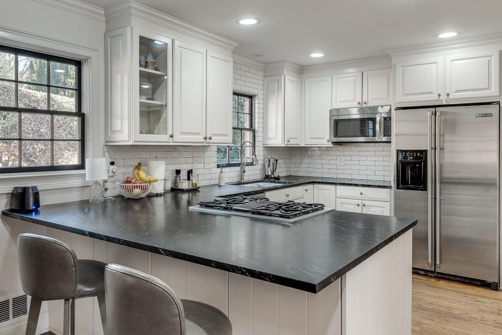 1846 Angelique Drive Decatur, GA 30033 - Photo 14 of 45 a kitchen with stainless steel appliances granite countertop a sink a stove and a refrigerator