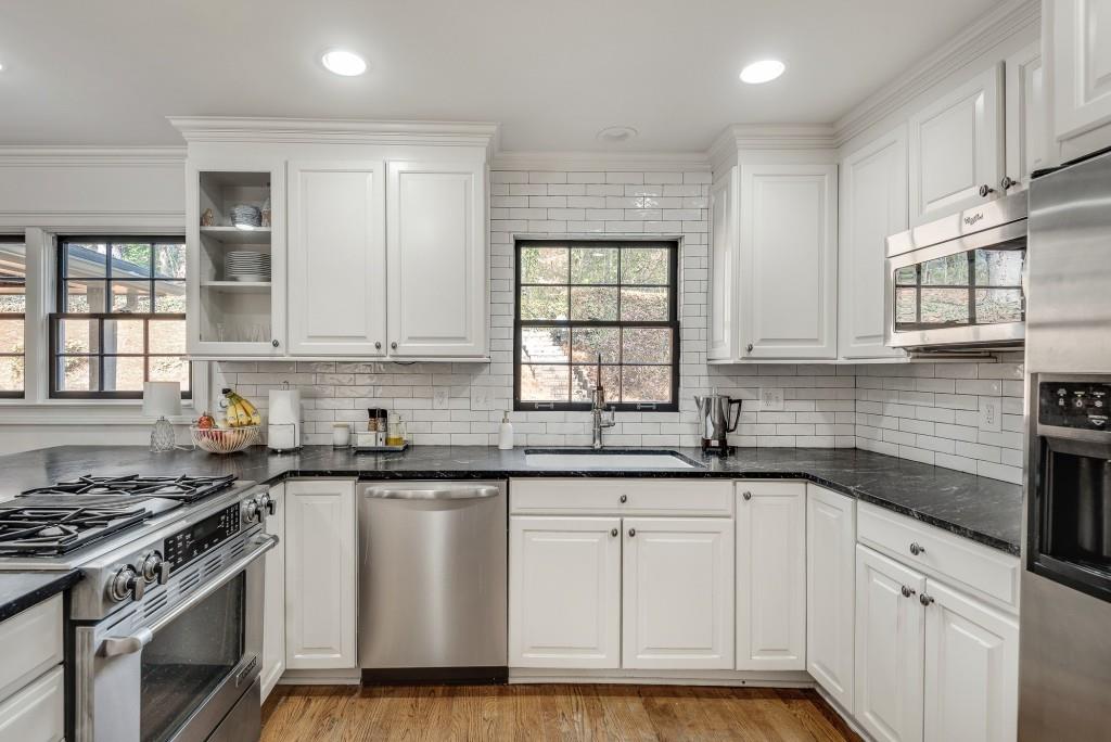 1846 Angelique Drive Decatur, GA 30033 - Photo 16 of 45 a kitchen with granite countertop white cabinets and appliances