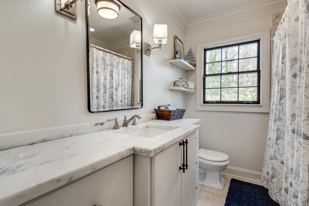 1846 Angelique Drive Decatur, GA 30033 - Photo 30 of 45 a bathroom with a granite countertop sink a toilet and a mirror