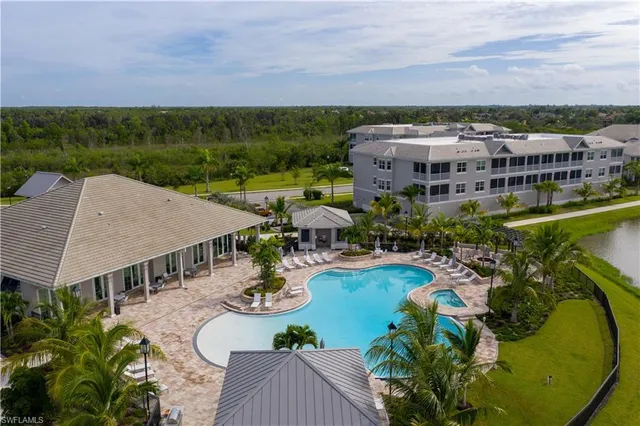 an aerial view of a house with swimming pool garden and patio