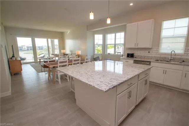 a kitchen with sink stove and cabinets