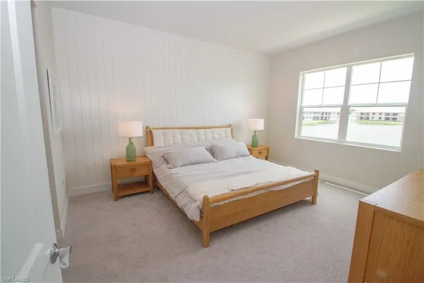 a bedroom with a bed and window