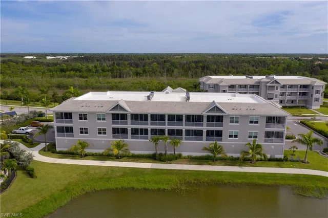 a view of a big house with a big yard and large trees