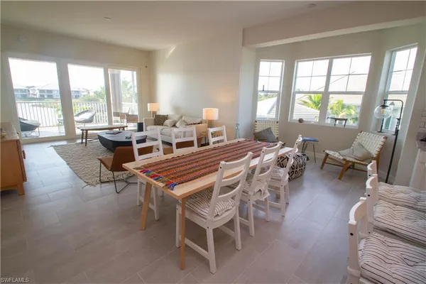 a living room with furniture a large window and a table