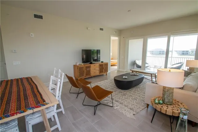 a living room with furniture a rug and a table