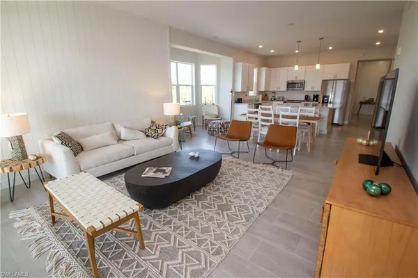 a living room with lots of furniture and kitchen view
