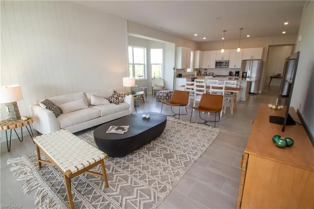 a living room with lots of furniture and kitchen view